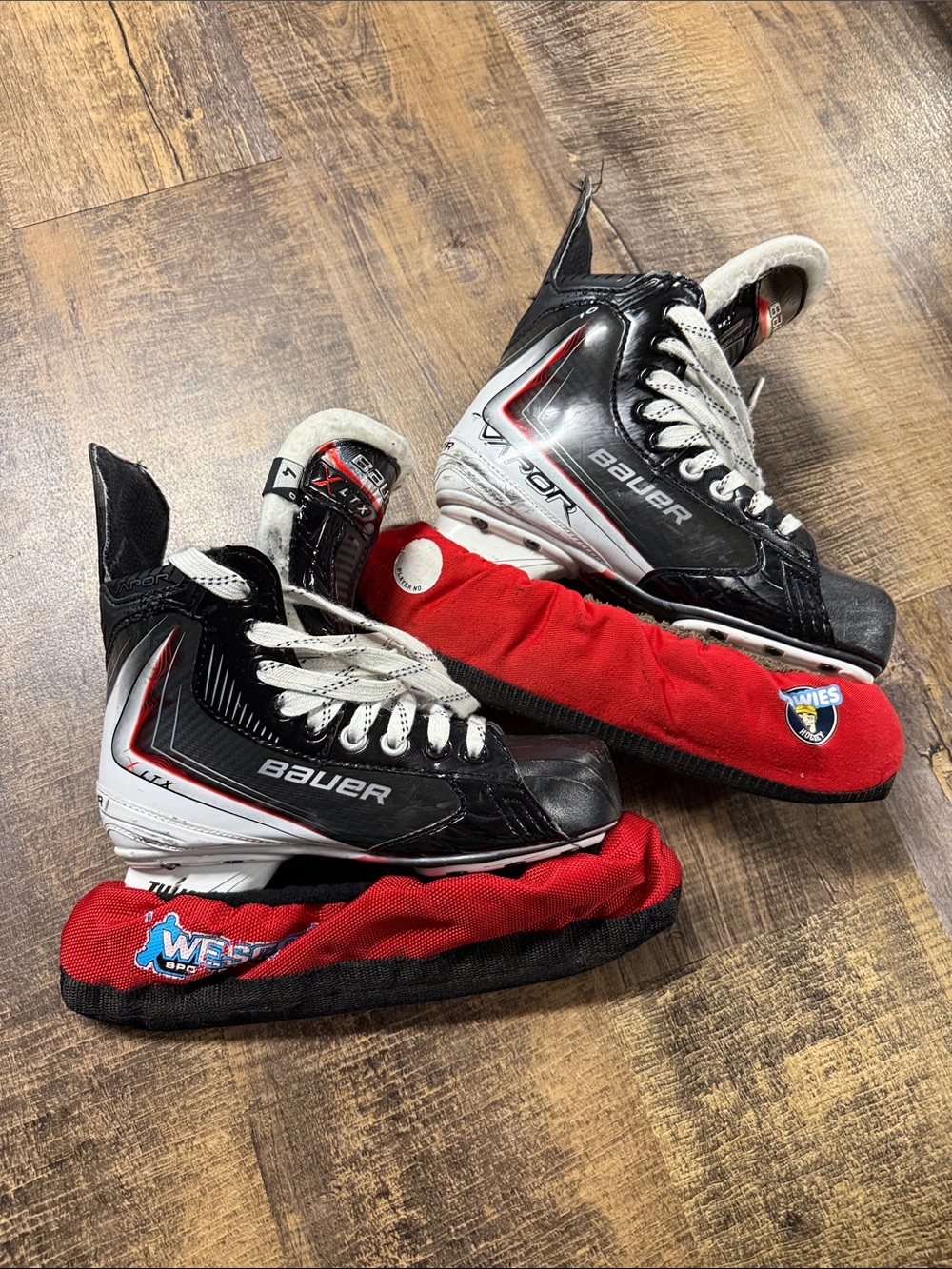 Bauer Black, White and Red Youth Hockey Skates with Red Blade Covers
